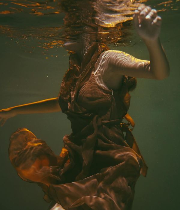 Woman in a calm seated pose, practicing gentle movement.